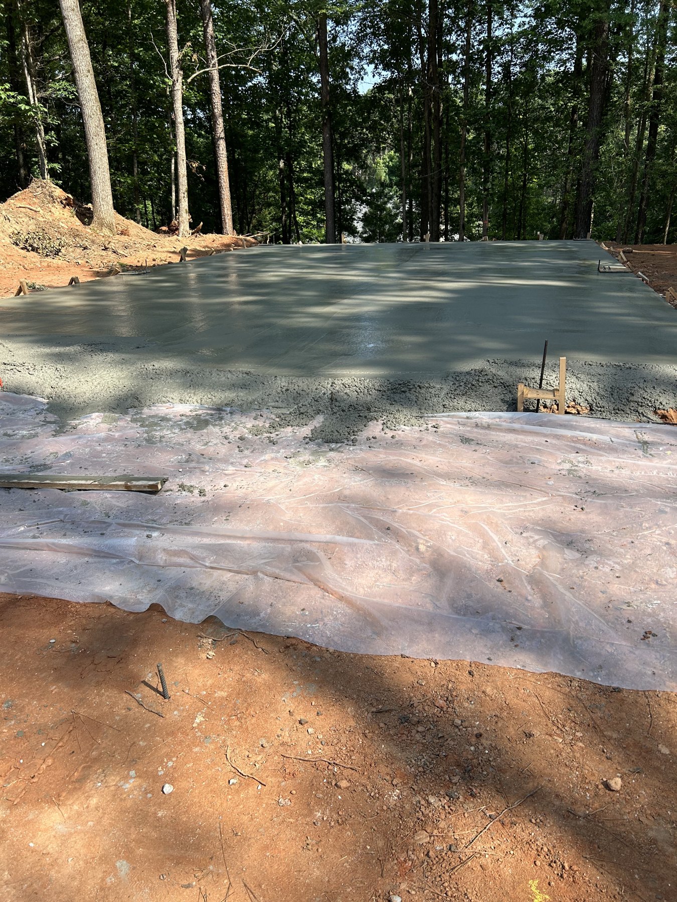 Large backyard slab finished concrete photo 3 Large backyard slab after photo 3 showing finished driveway and pad concrete work by Colquitt Concrete in Georgia