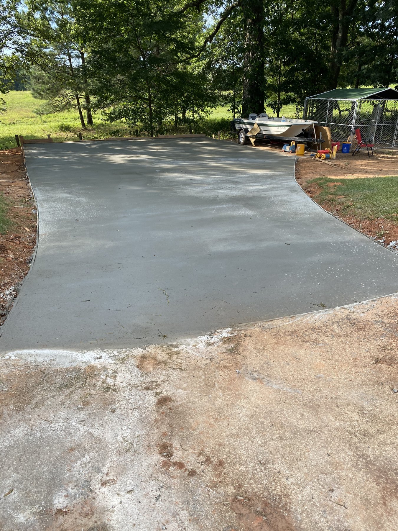 Large backyard slab finished concrete photo 4 Large backyard slab after photo 4 showing finished driveway and pad concrete work by Colquitt Concrete in Georgia