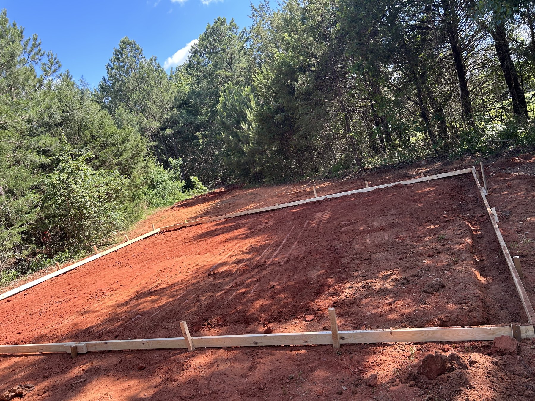 Large backyard slab before concrete work photo 4 Large backyard slab before photo 4 showing driveway and pad concrete preparation by Colquitt Concrete in Georgia