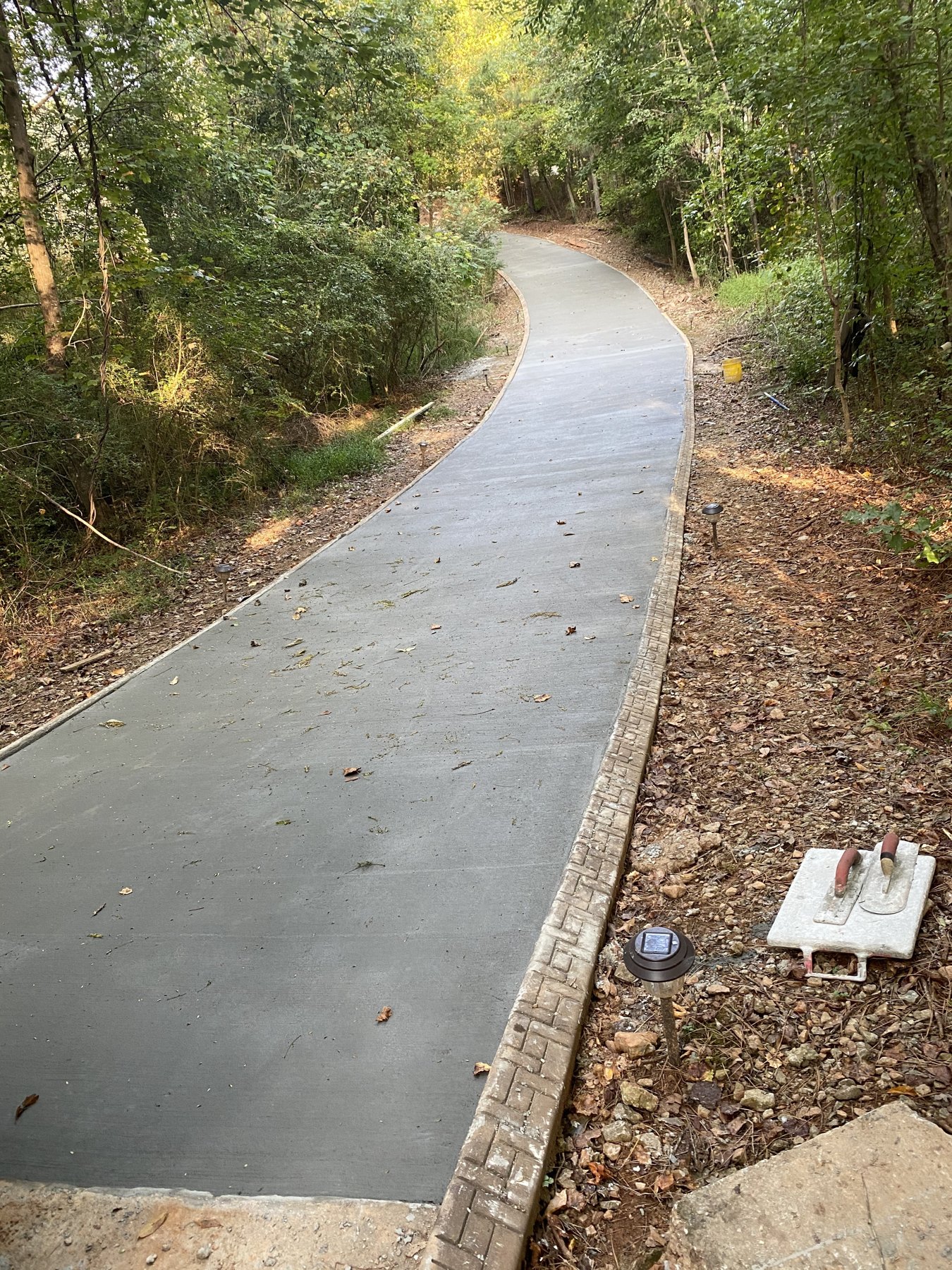 Curved walkway finished concrete photo 5 Curved walkway after photo 5 showing finished walkway concrete work by Colquitt Concrete in Georgia