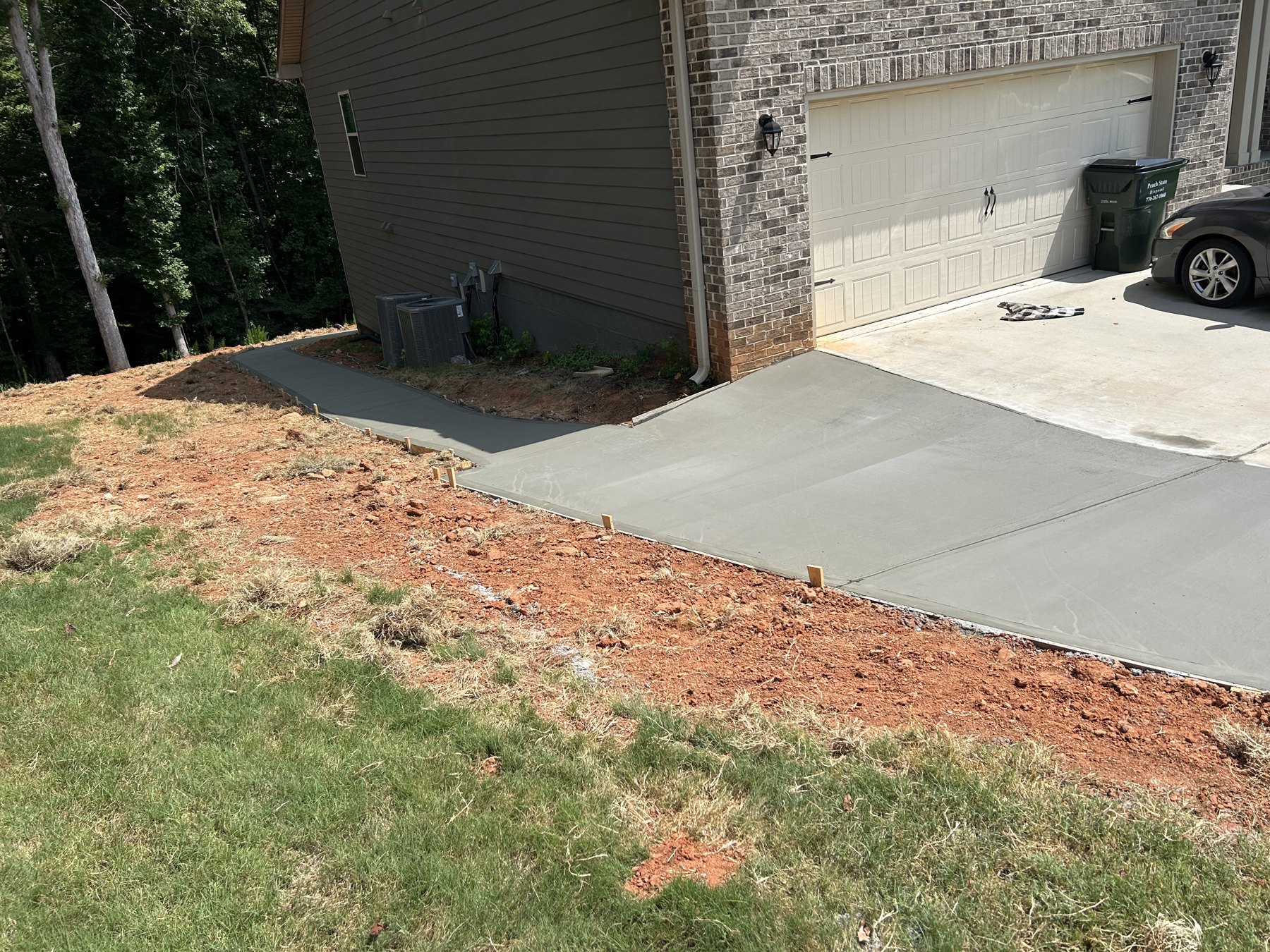 Garage walkway approach finished concrete photo 2 Garage walkway approach after photo 2 showing finished walkway concrete work by Colquitt Concrete in Georgia