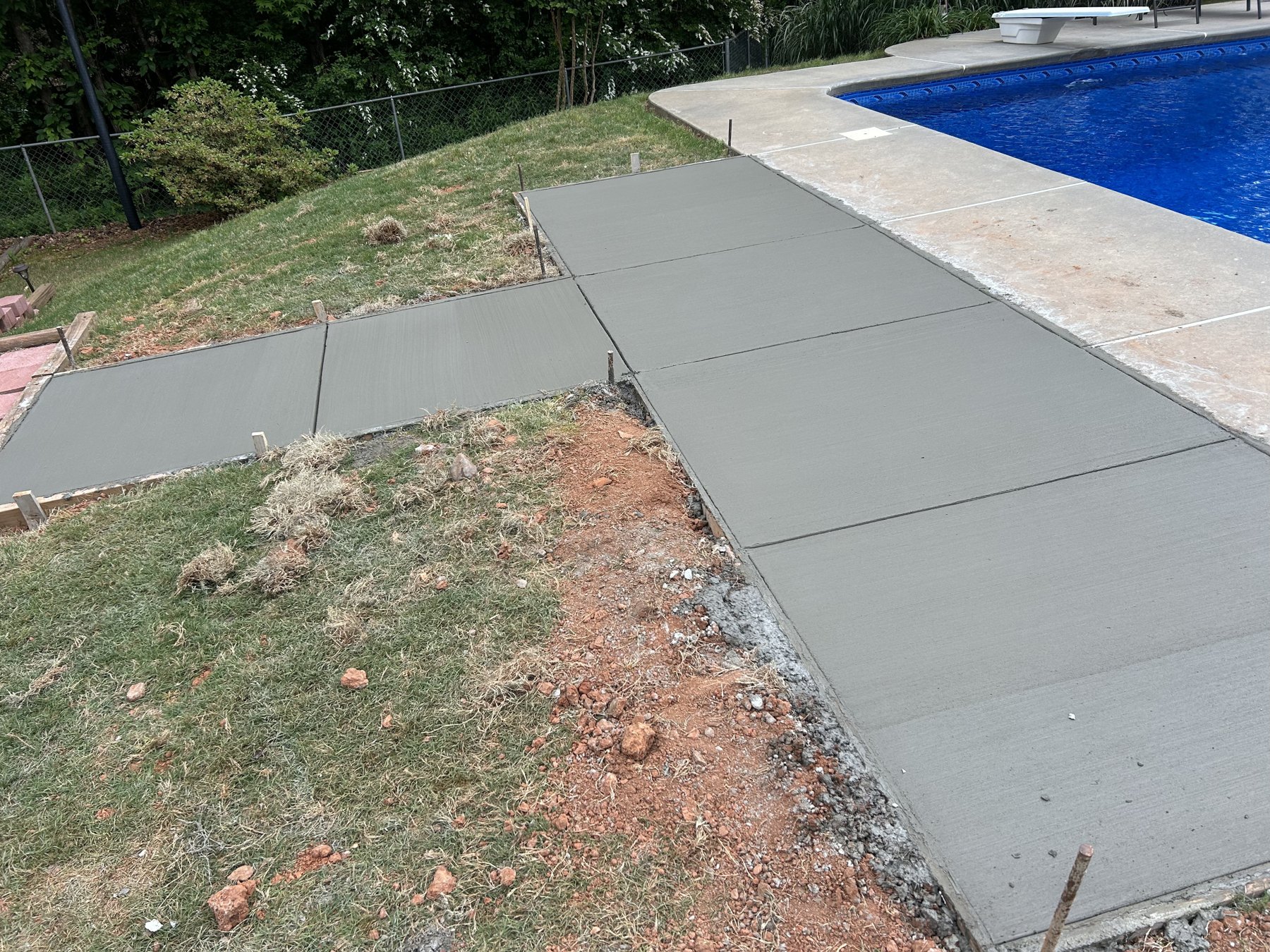Pool deck extension finished concrete photo 3 Pool deck extension after photo 3 showing finished pool deck concrete work by Colquitt Concrete in Georgia