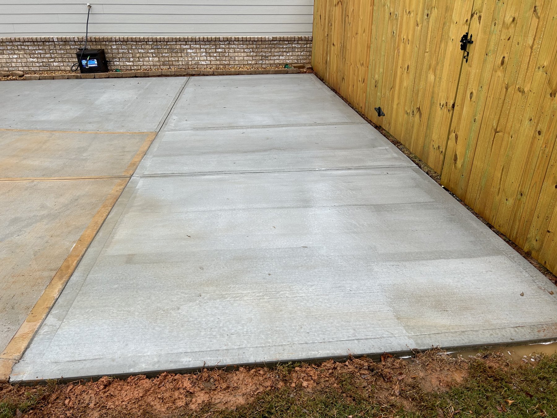 Side driveway extension finished concrete photo 2 Side driveway extension after photo 2 showing finished driveway concrete work by Colquitt Concrete in Georgia